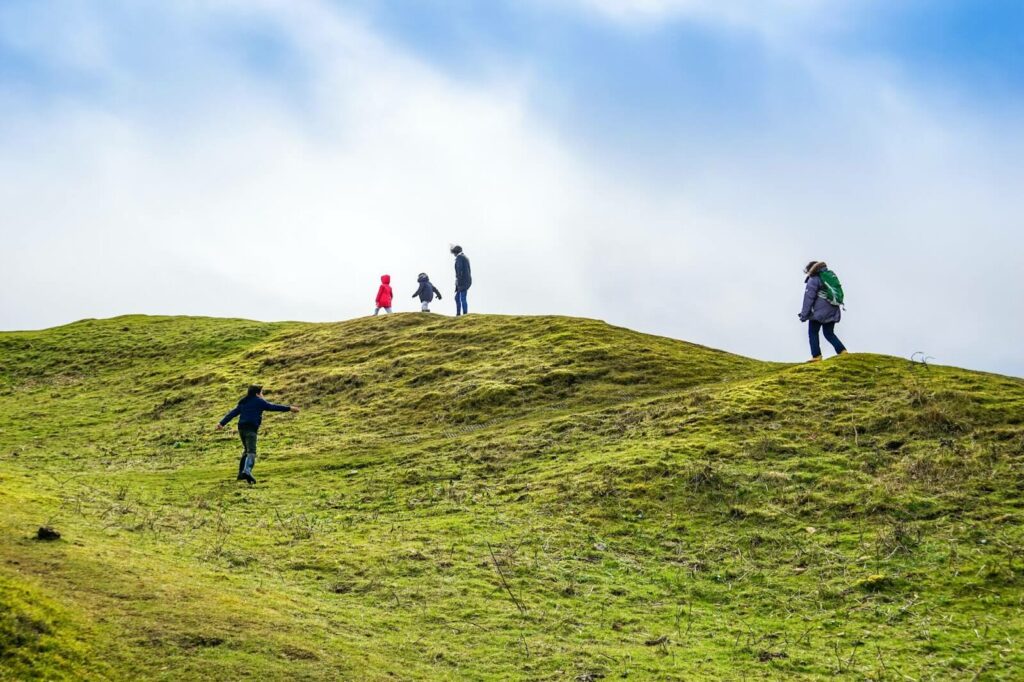 Walking along green hills